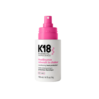 K18 HeatBounce hair product bottle with pink spray nozzle on a white background